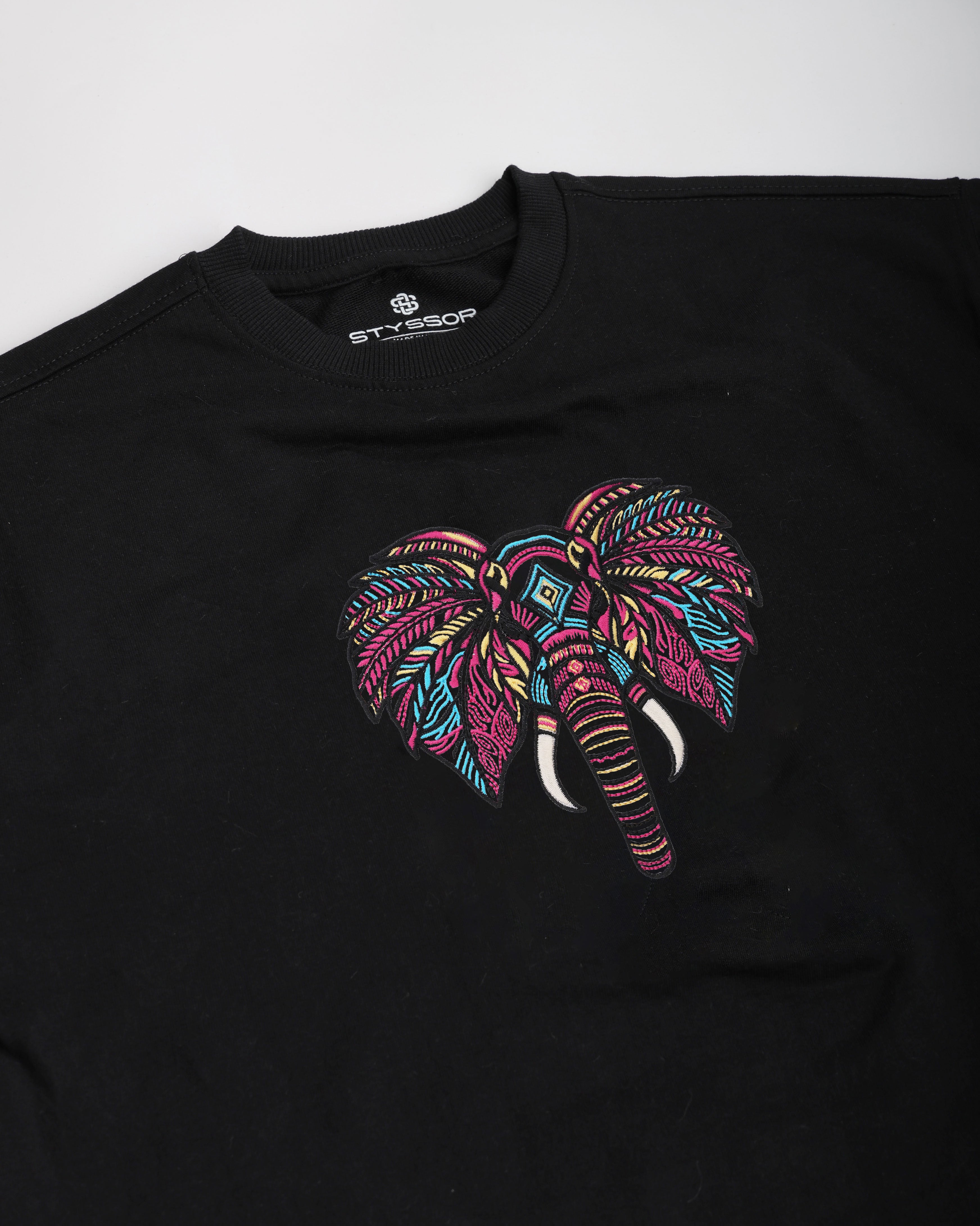 Black t-shirt with a colorful elephant design on a white background