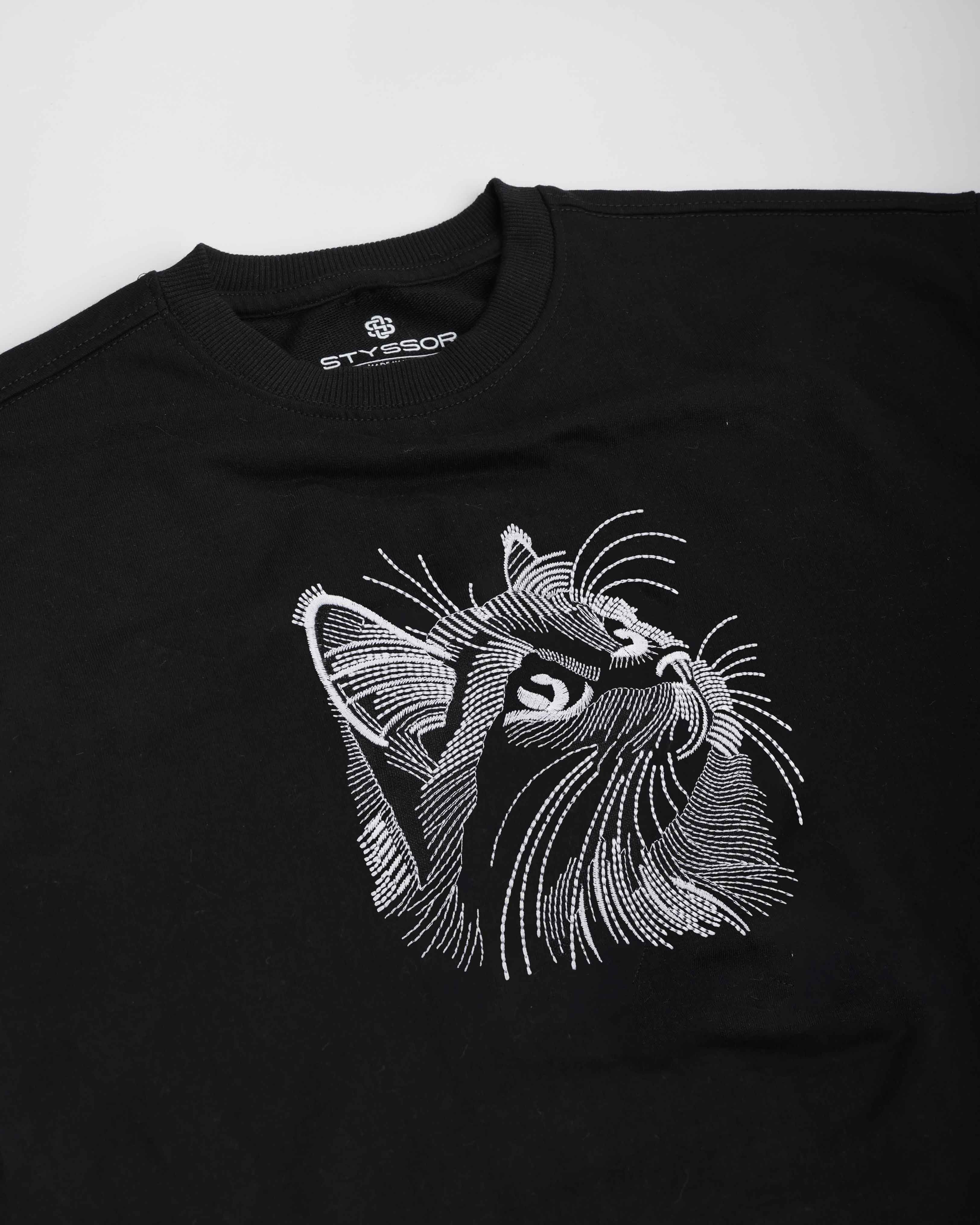 Black t-shirt with a white cat graphic on a white background