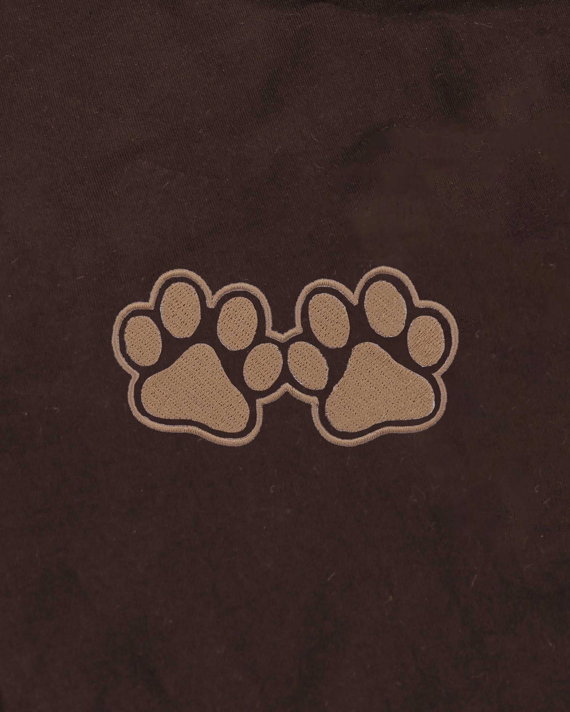 Two paw prints on a brown background
