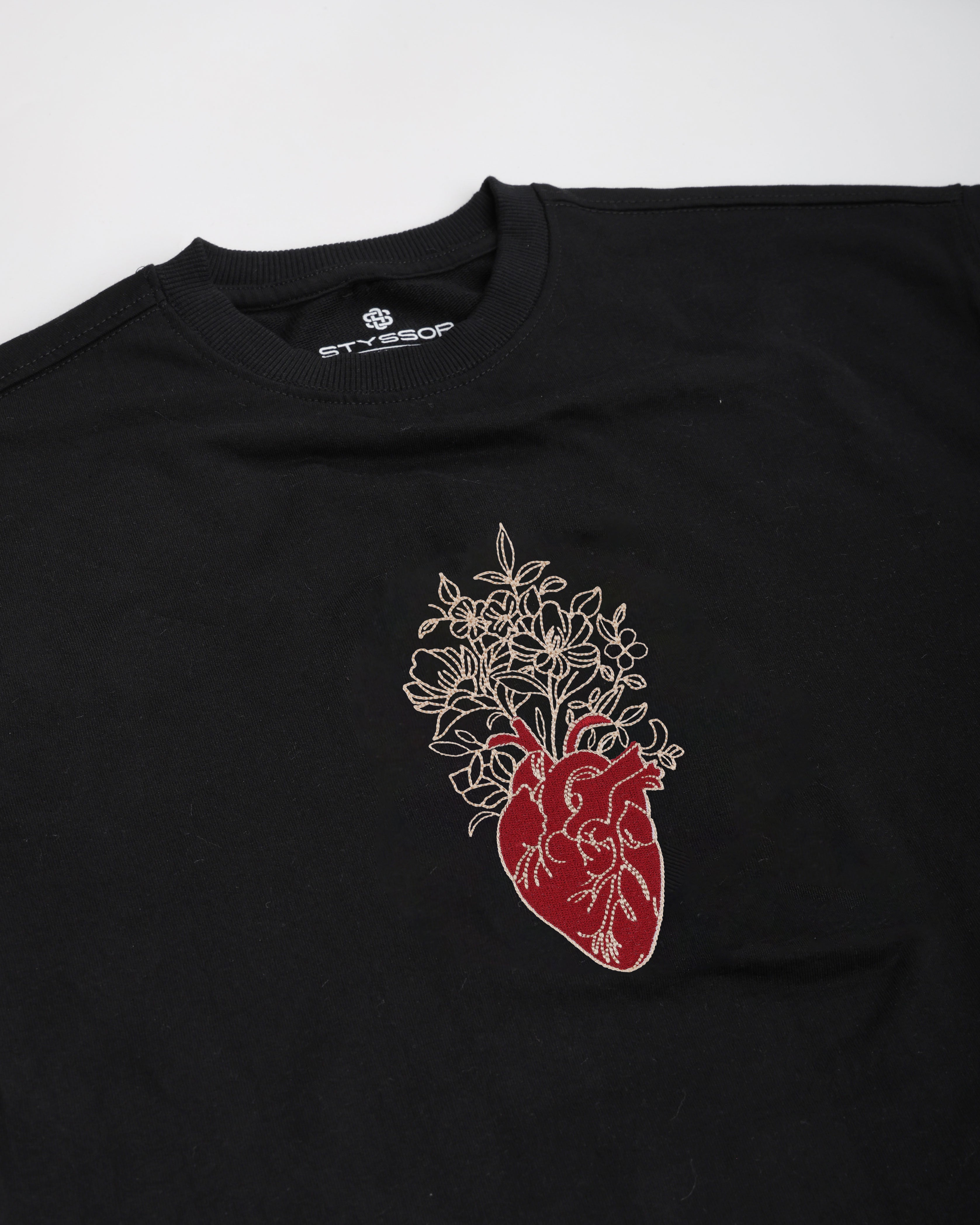 Black t-shirt with a red and white anatomical heart design on a white background