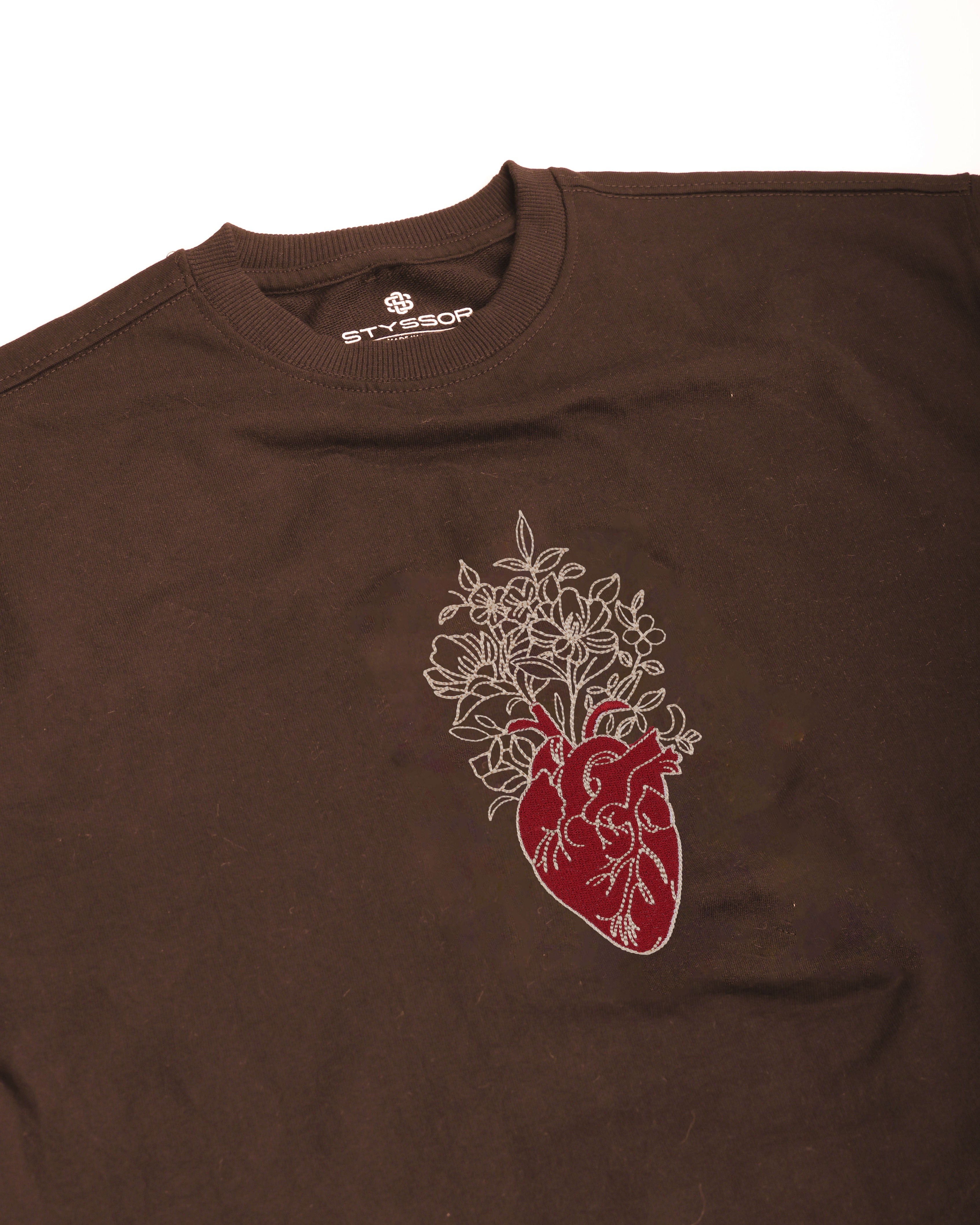 Brown t-shirt with a heart design on a white background