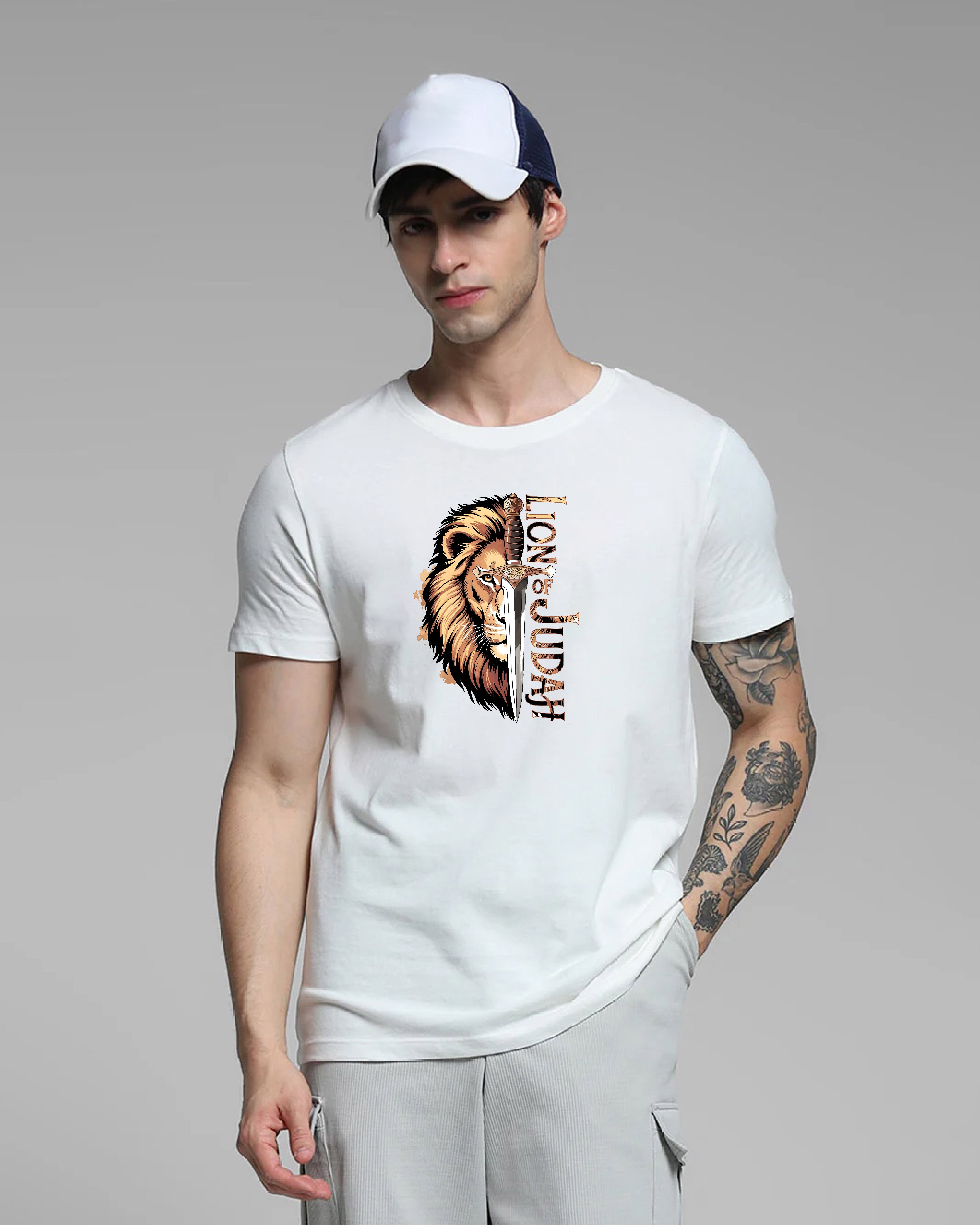 Man wearing a white t-shirt with a lion graphic and text, standing against a gray background