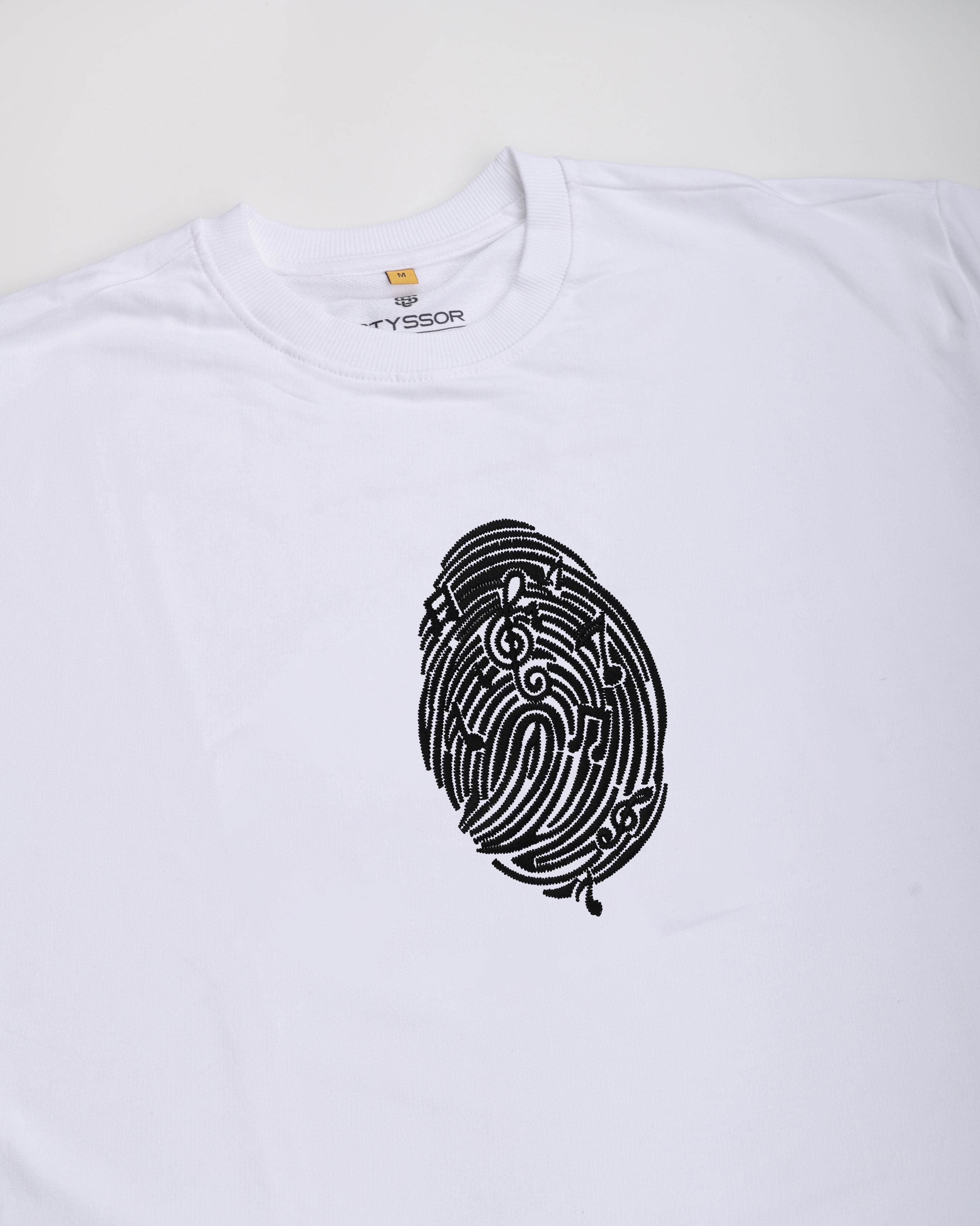 White t-shirt with black fingerprint design and 'Fyssor' branding on a white background