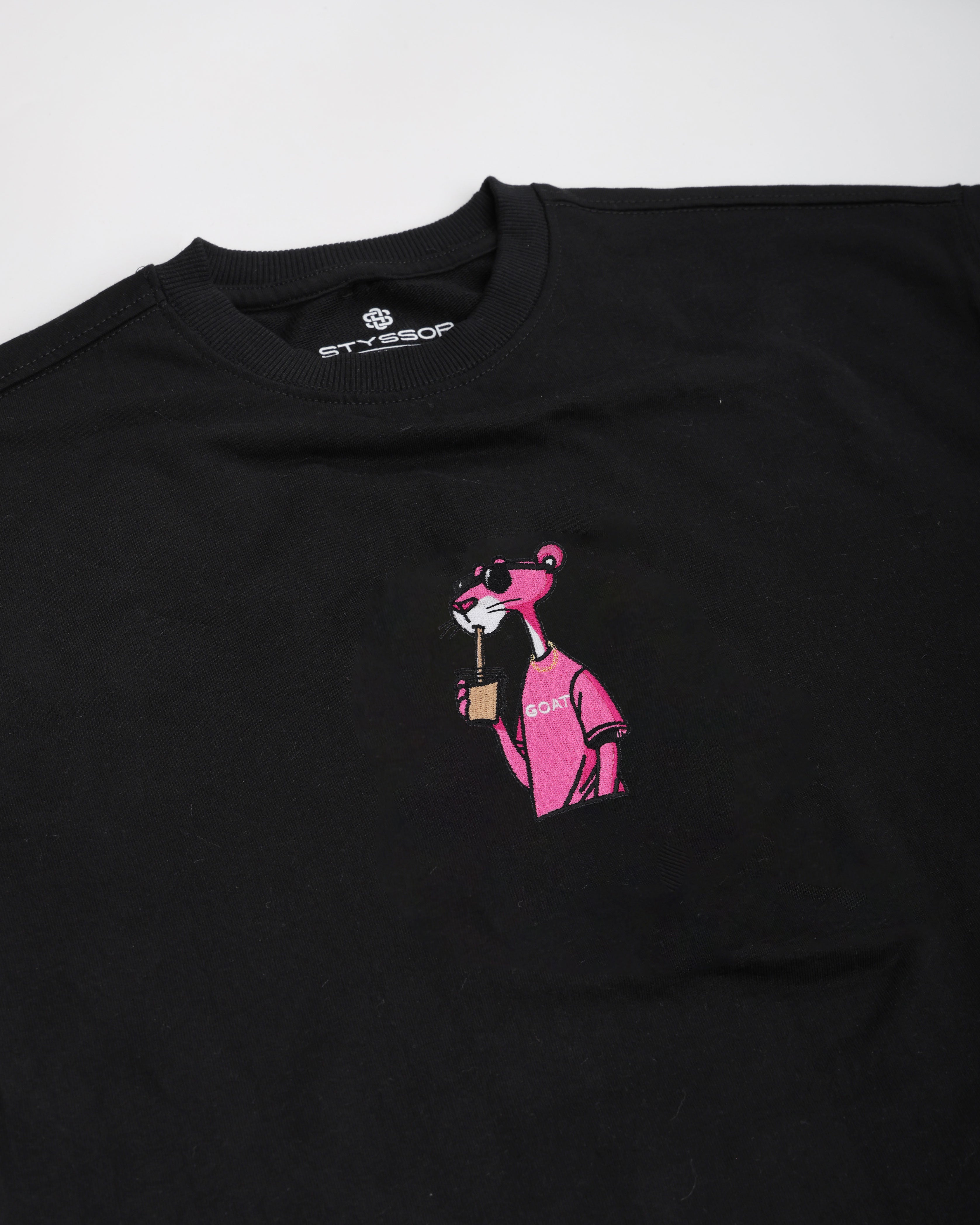 Black t-shirt with pink graphic of a dog and text on a white background
