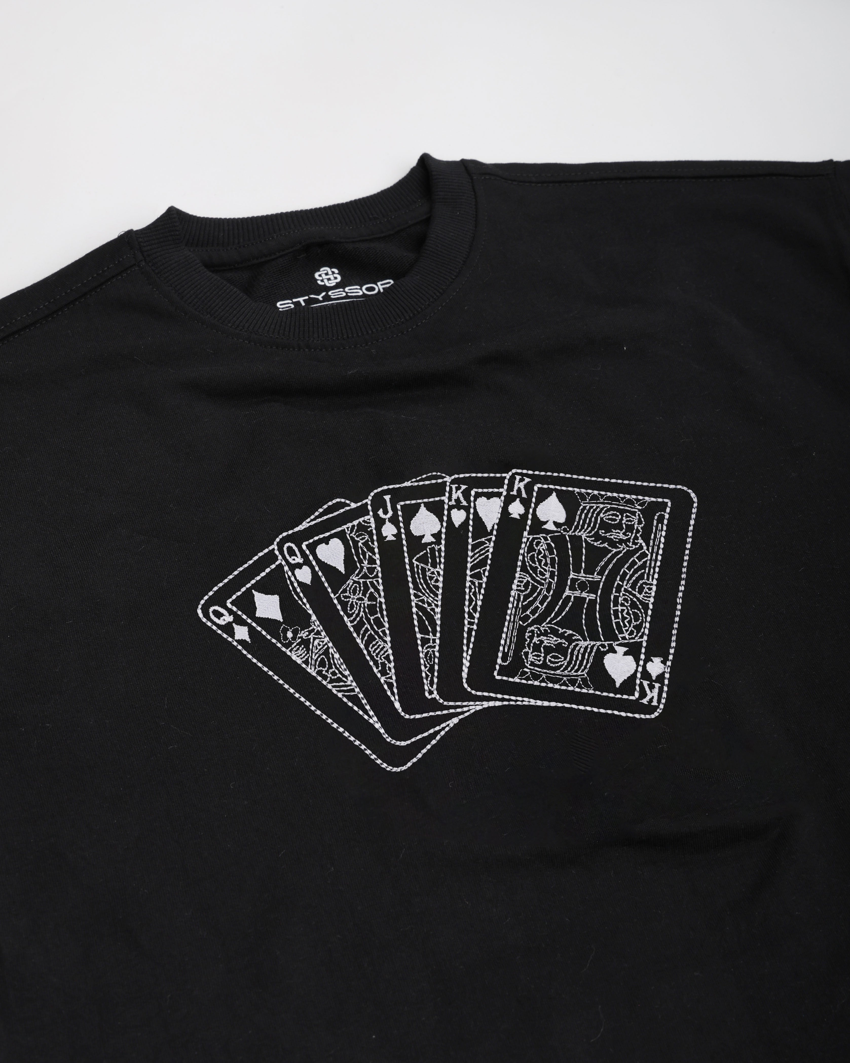 Black t-shirt with white playing card design on a white background