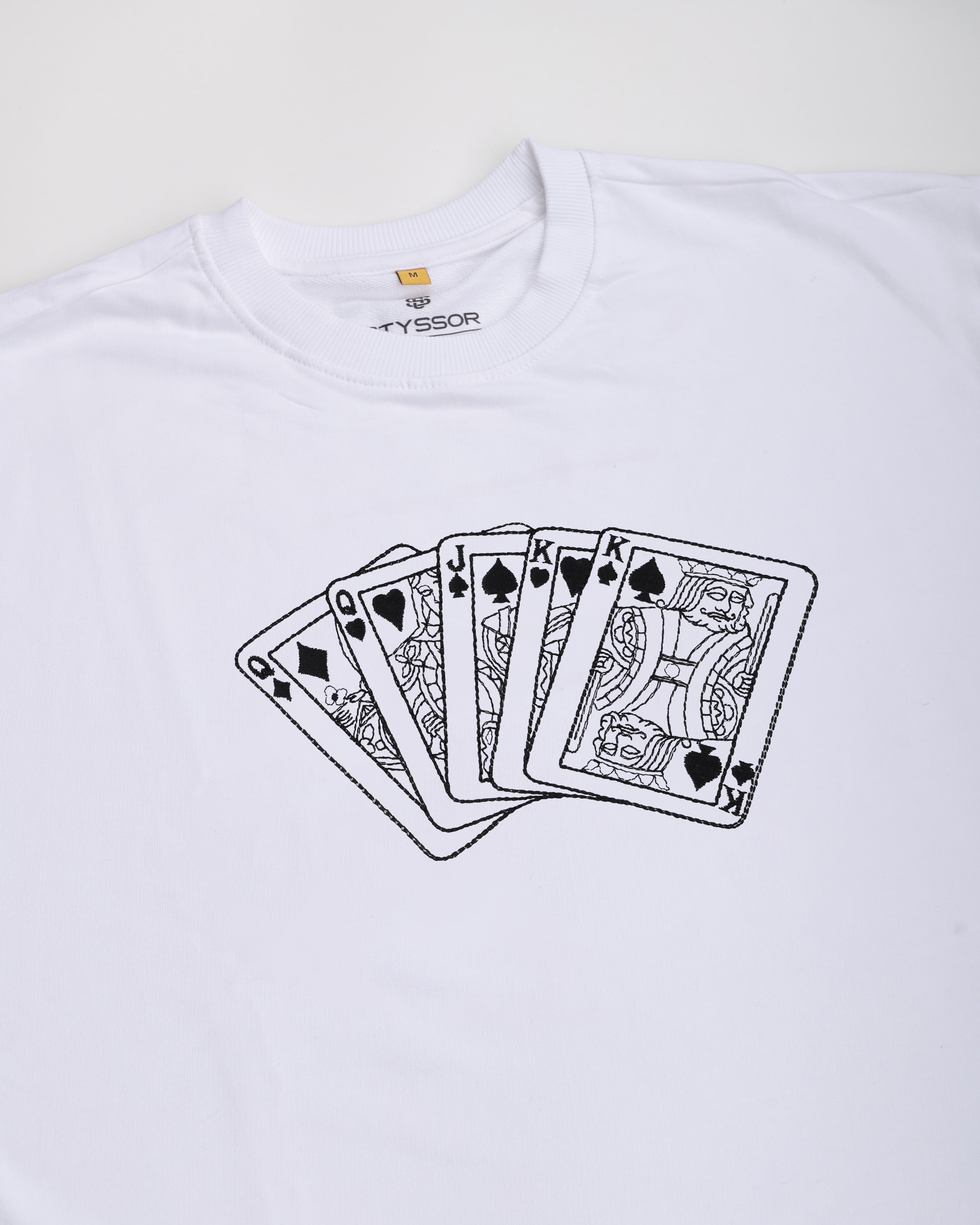 White t-shirt with black playing card design on a white background