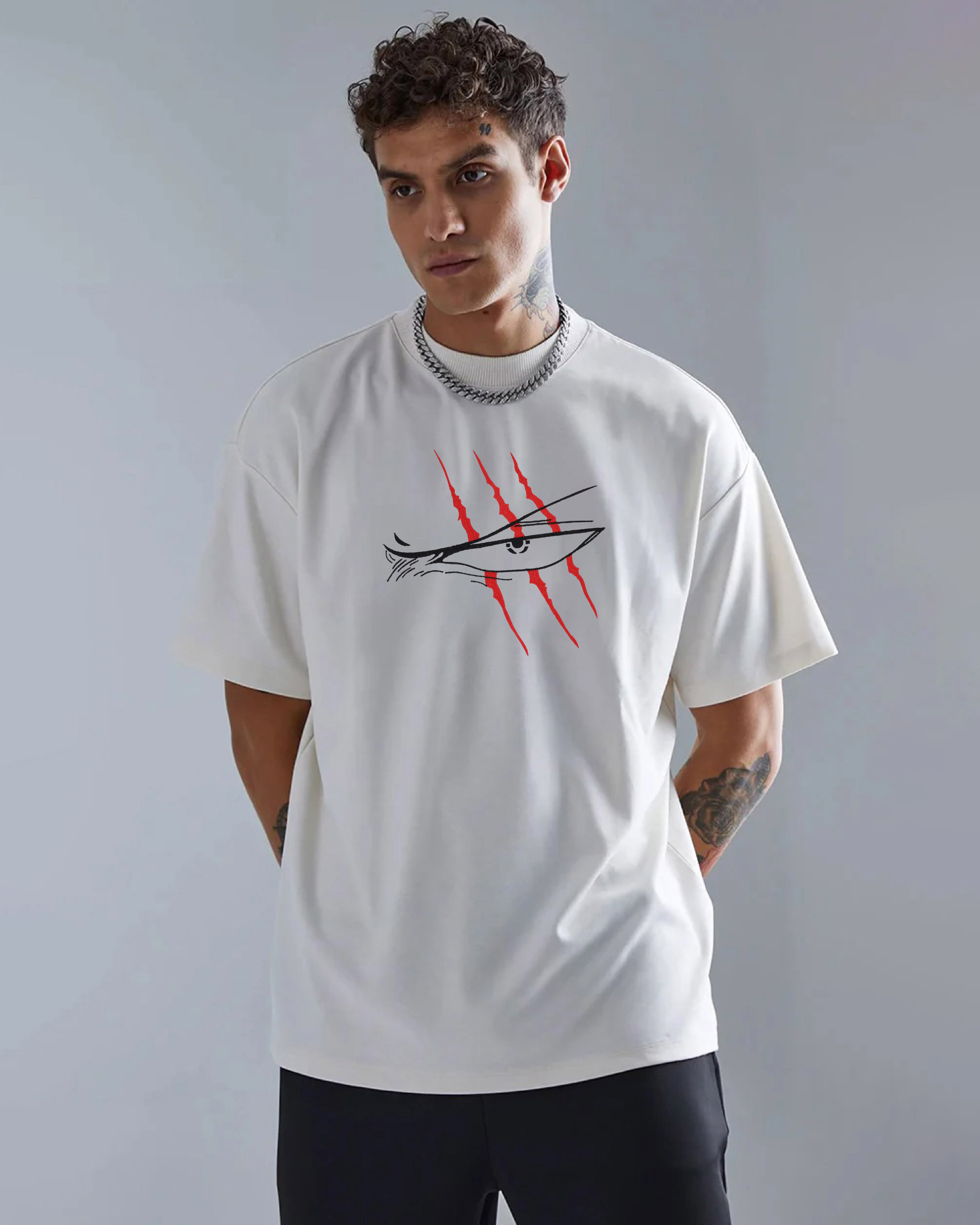 Man wearing a white t-shirt with a graphic design on a gray background