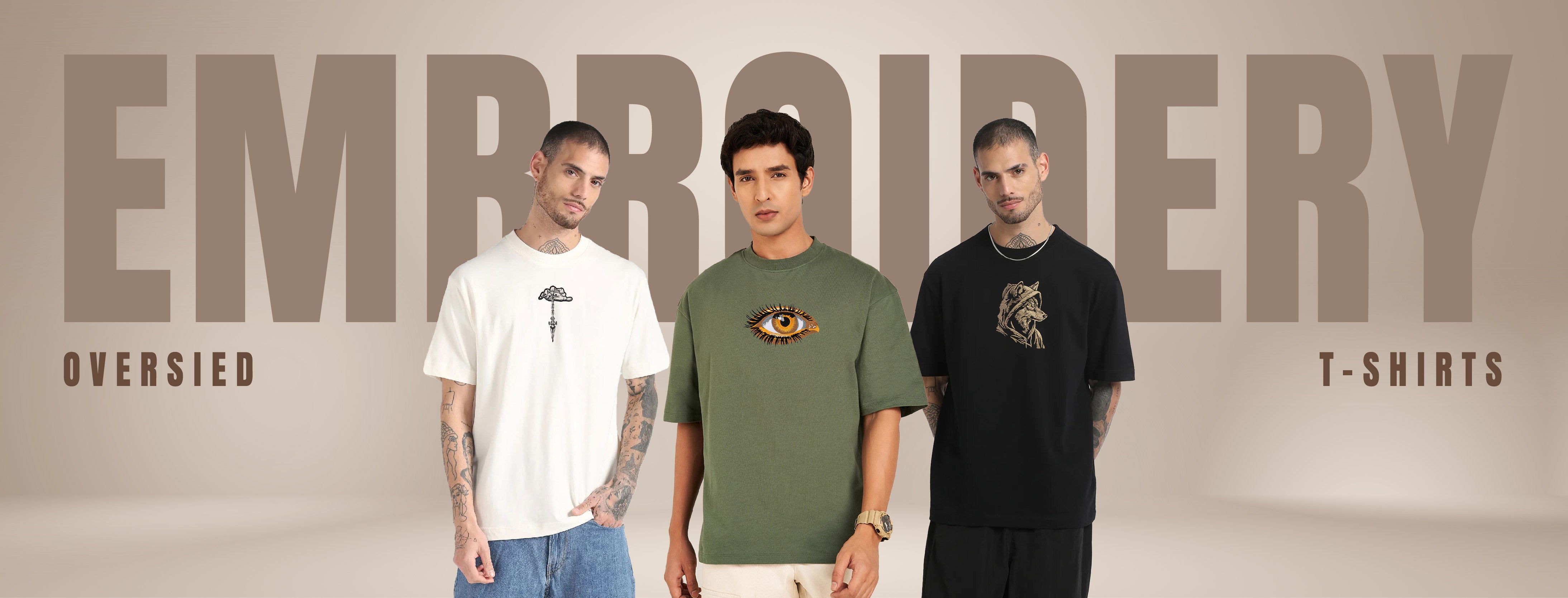 Three men wearing embroidered t-shirts with a 'Embroidery' banner in the background.