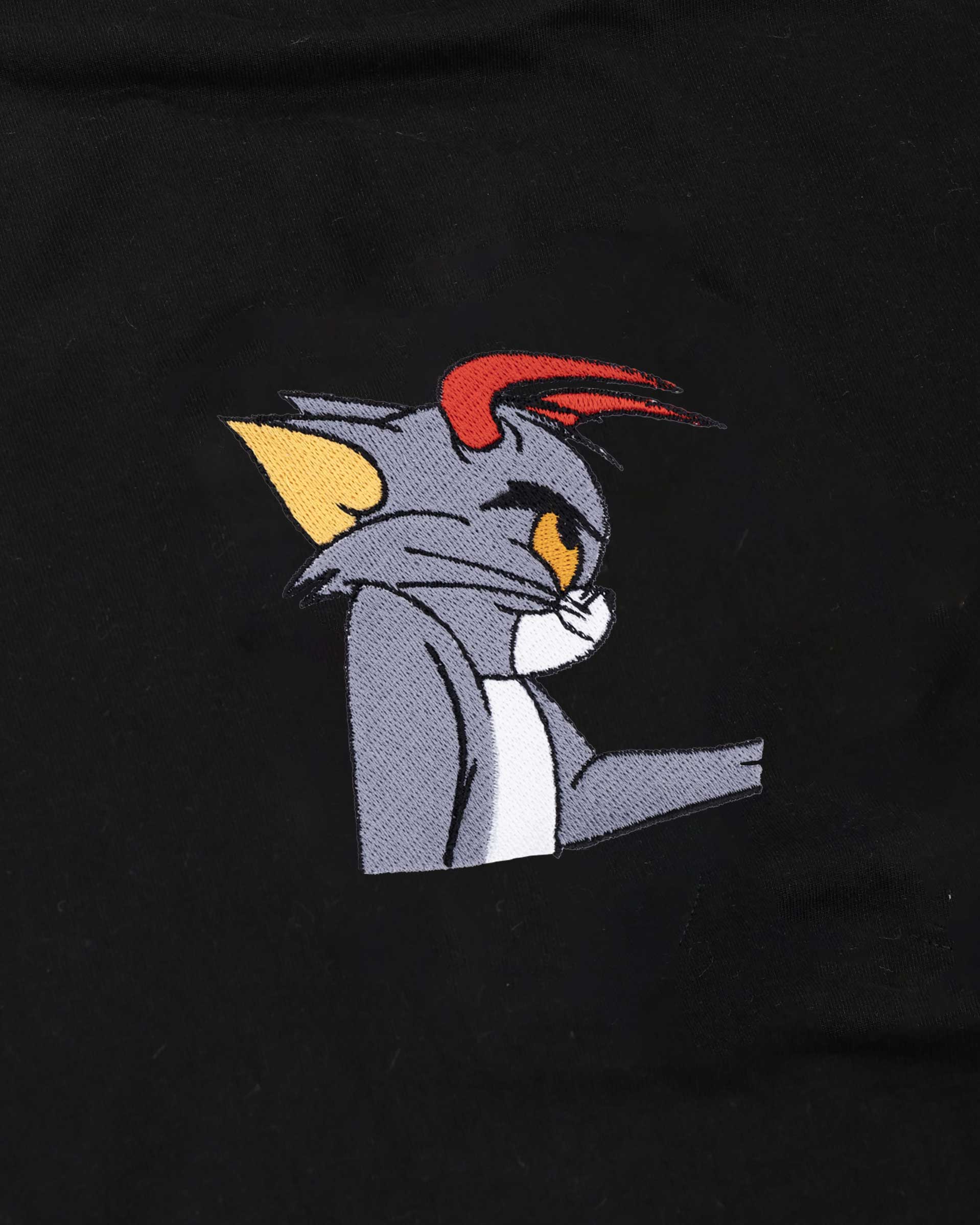 Embroidered cartoon character on a black background