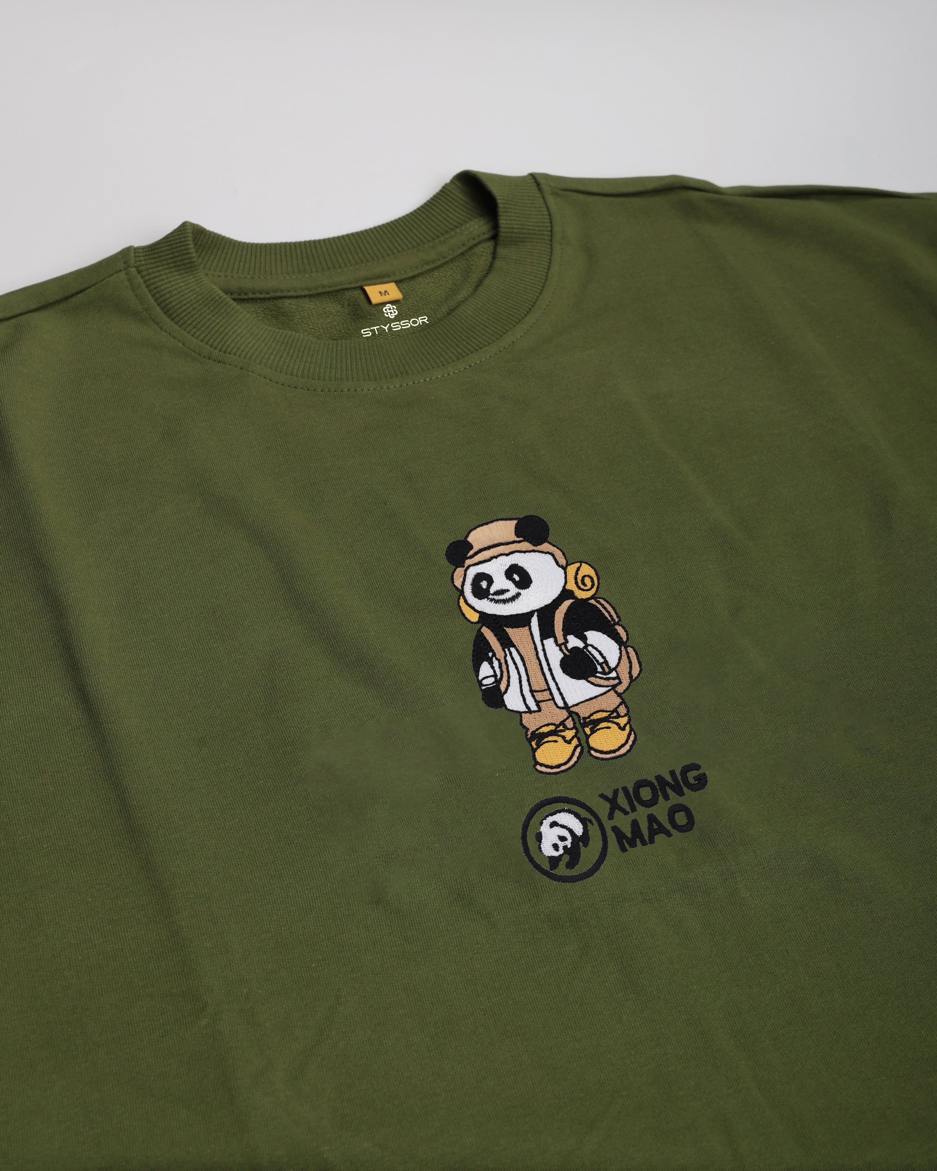 Green t-shirt with a panda design and 'Xiong Mao' logo on a white background
