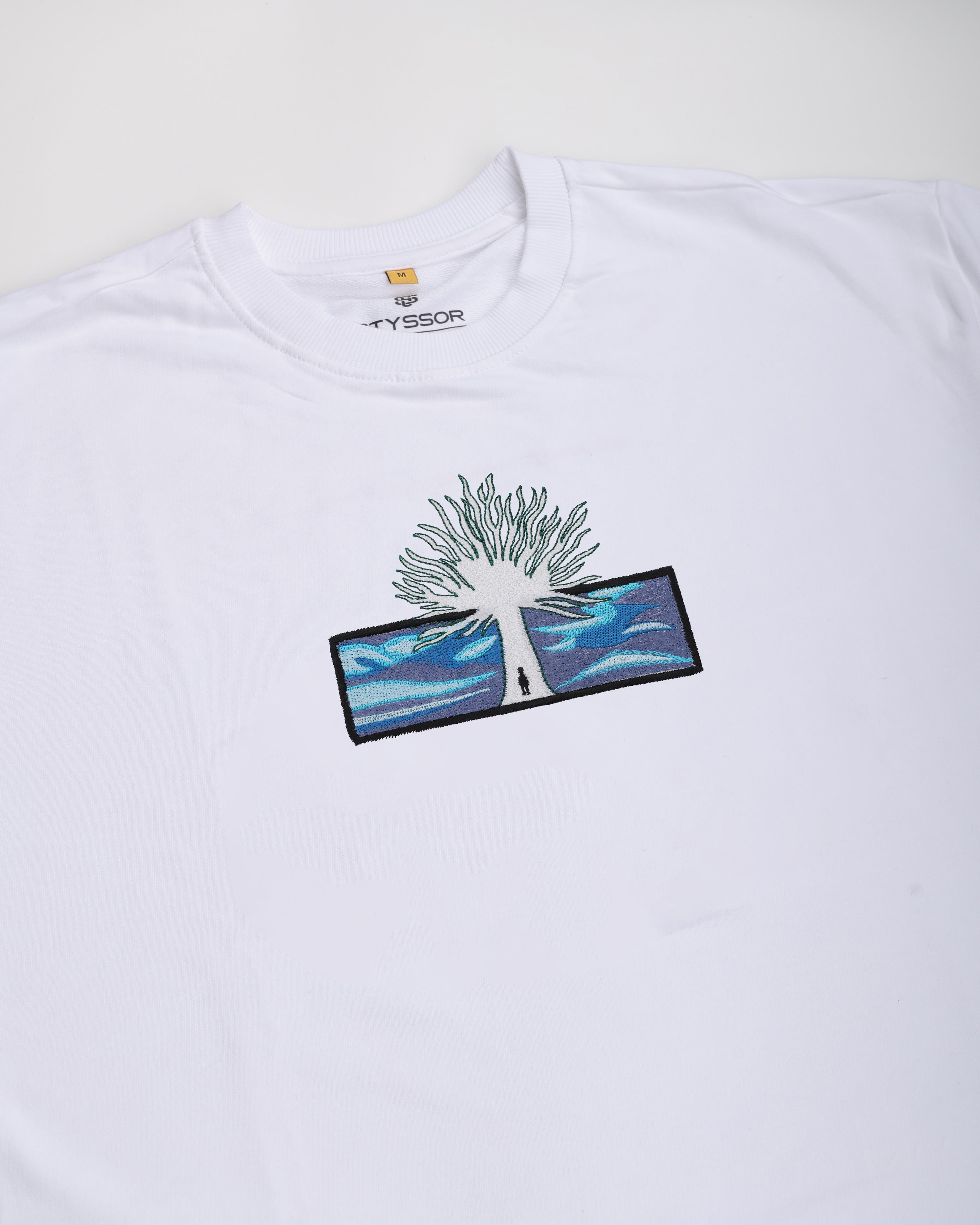 White t-shirt with a tree design and 'Fjällräven' branding on a white background