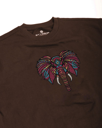 Brown t-shirt with a colorful elephant design on a white background