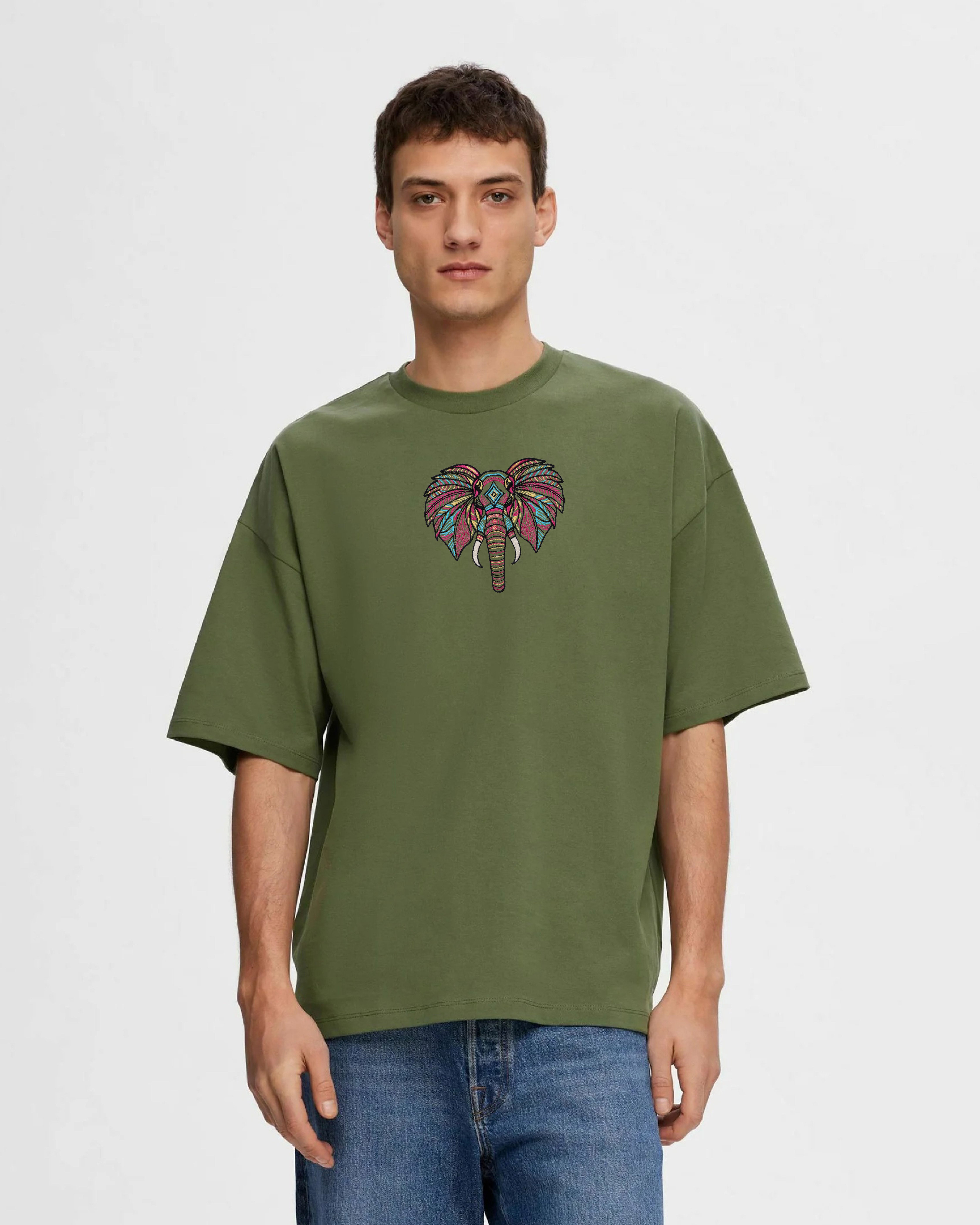 Man wearing a green t-shirt with a colorful Elephant design on a plain background