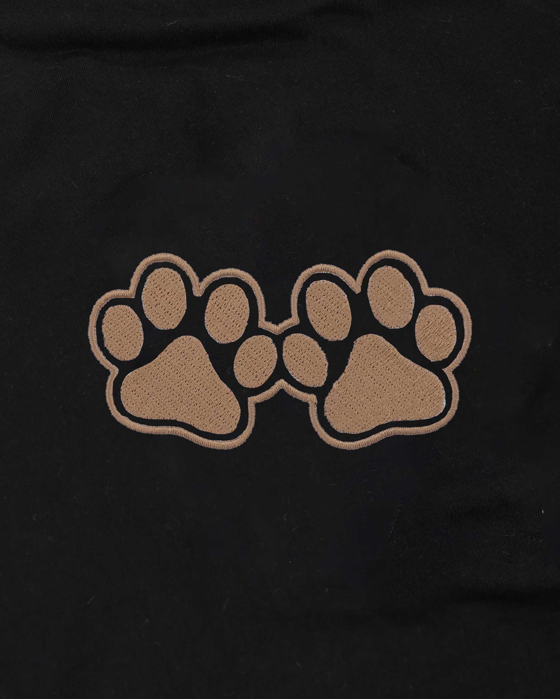 Two brown paw prints on a black background