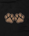Two brown paw prints on a black background