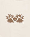 Two brown paw prints on a beige background