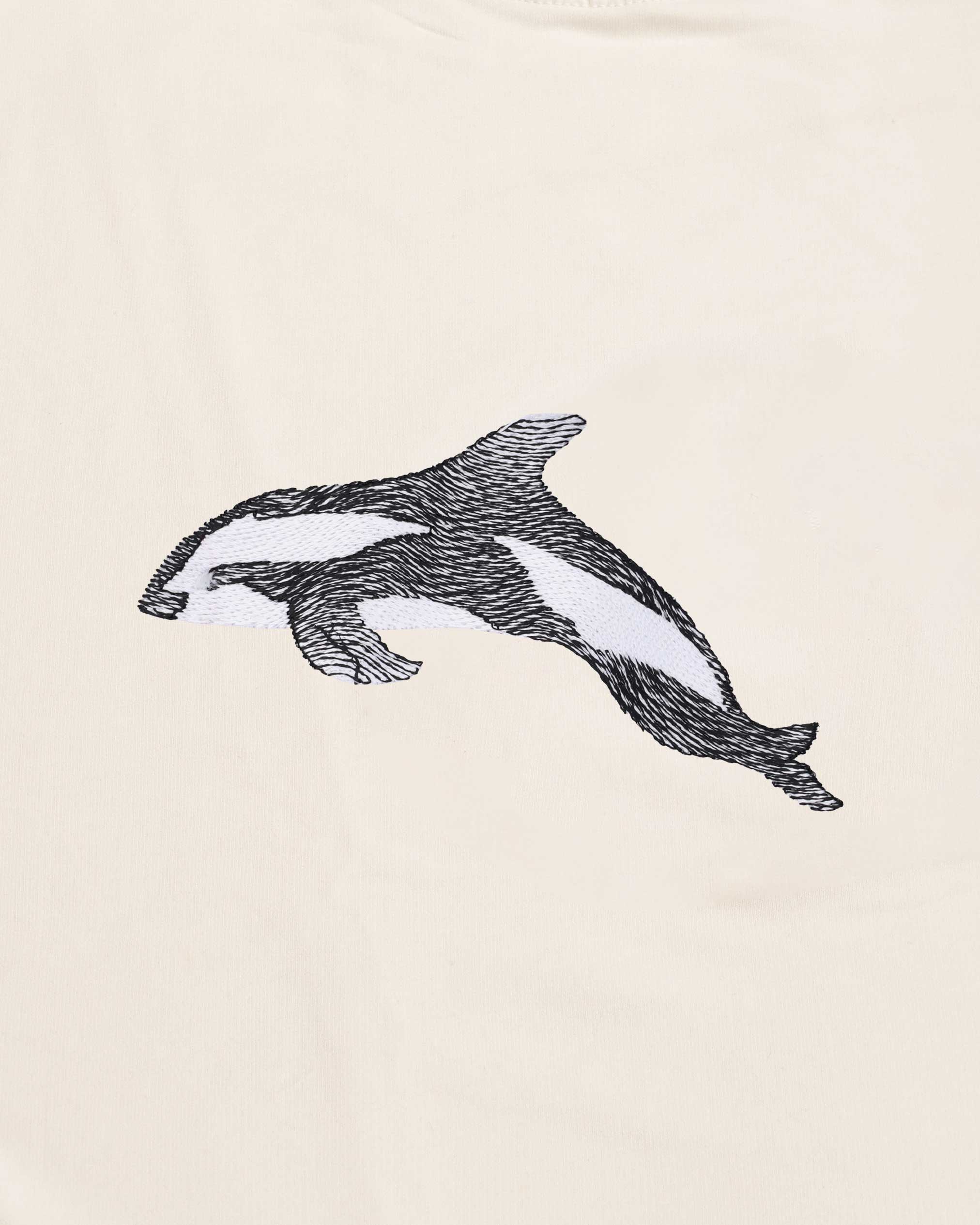 Black and white illustration of a dolphin on a beige background