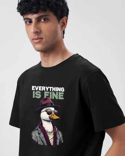 Person wearing a black t-shirt with a graphic of a duck in a suit and sunglasses and the text 'Everything is Fine'.