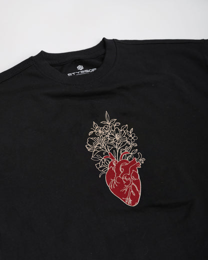 Black t-shirt with a red and white anatomical heart design on a white background