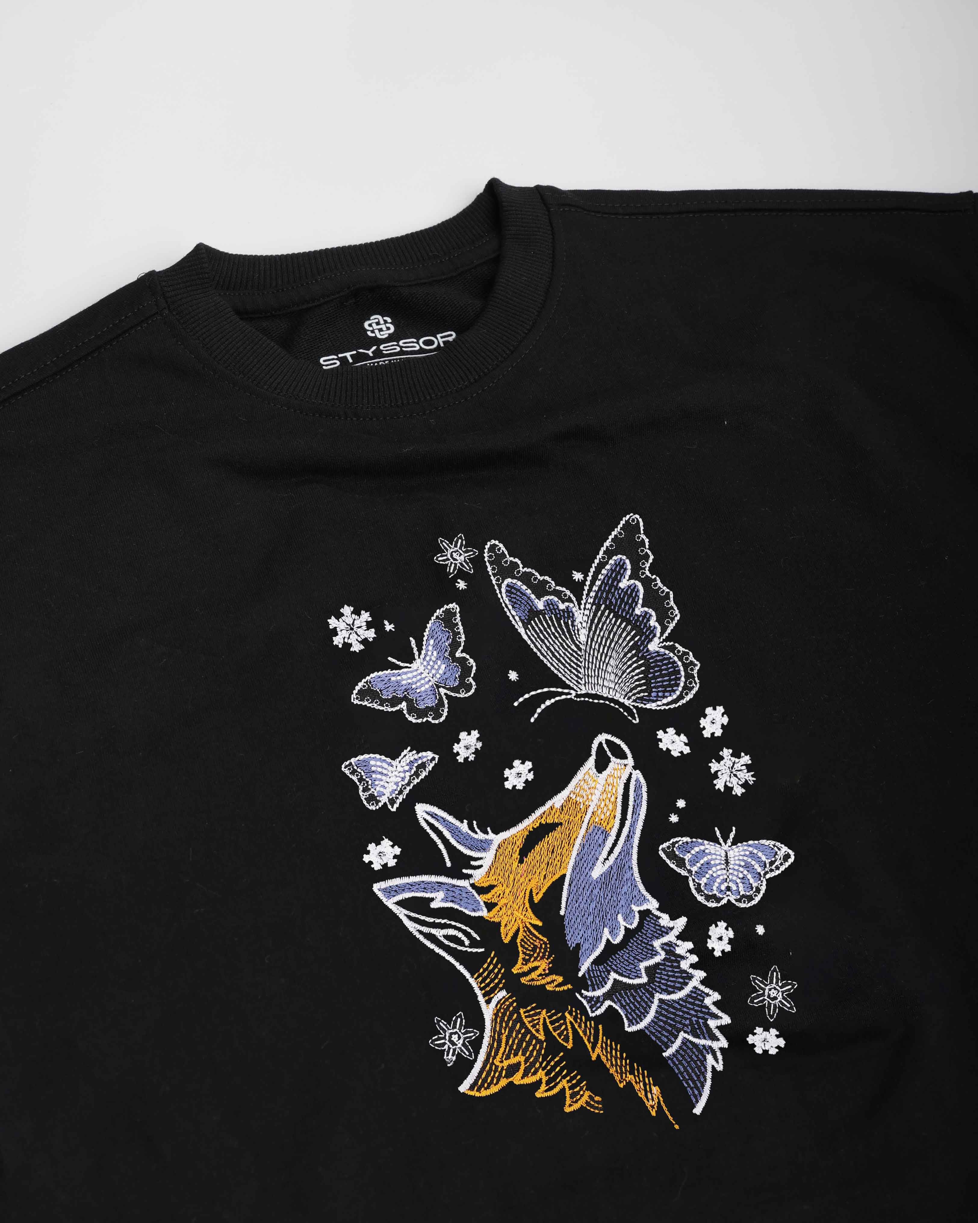Black t-shirt with a wolf and butterfly design on a white background