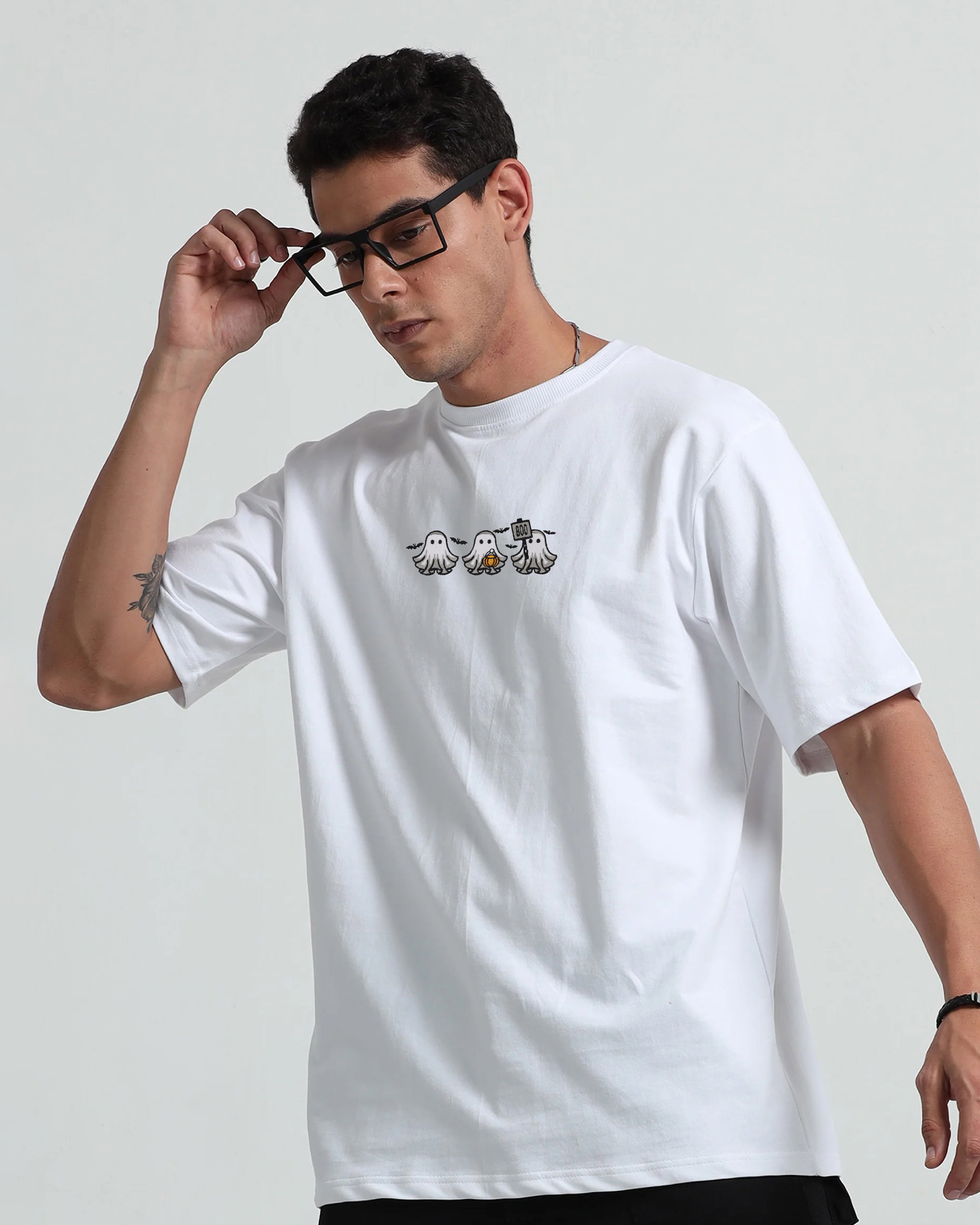 Man wearing a white t-shirt with a logo on a plain background