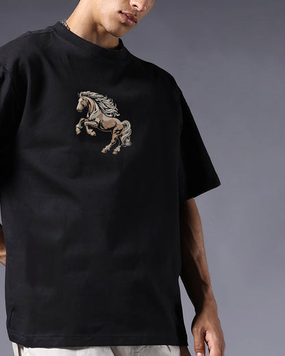 Person wearing a black t-shirt with a horse graphic on a gray background