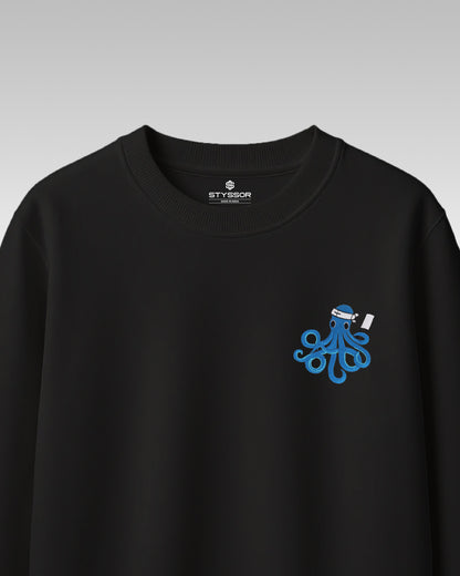 Black sweatshirt with a blue octopus design on a gray background
