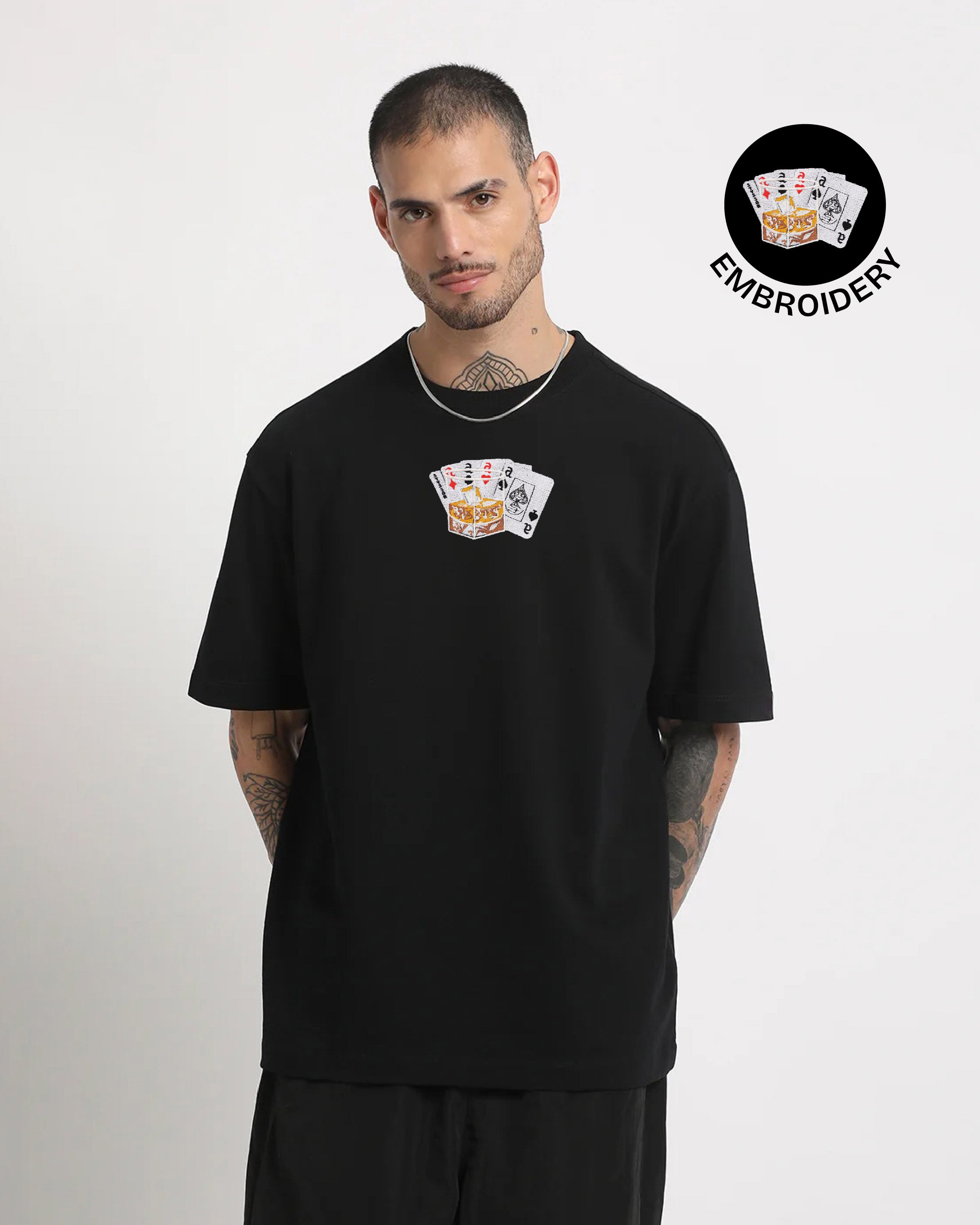 Man wearing a black t-shirt with card design on a white background, featuring an embroidery logo.