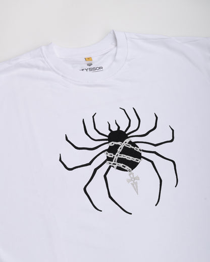 White t-shirt with a black spider graphic and 'Syssor' branding on a white background