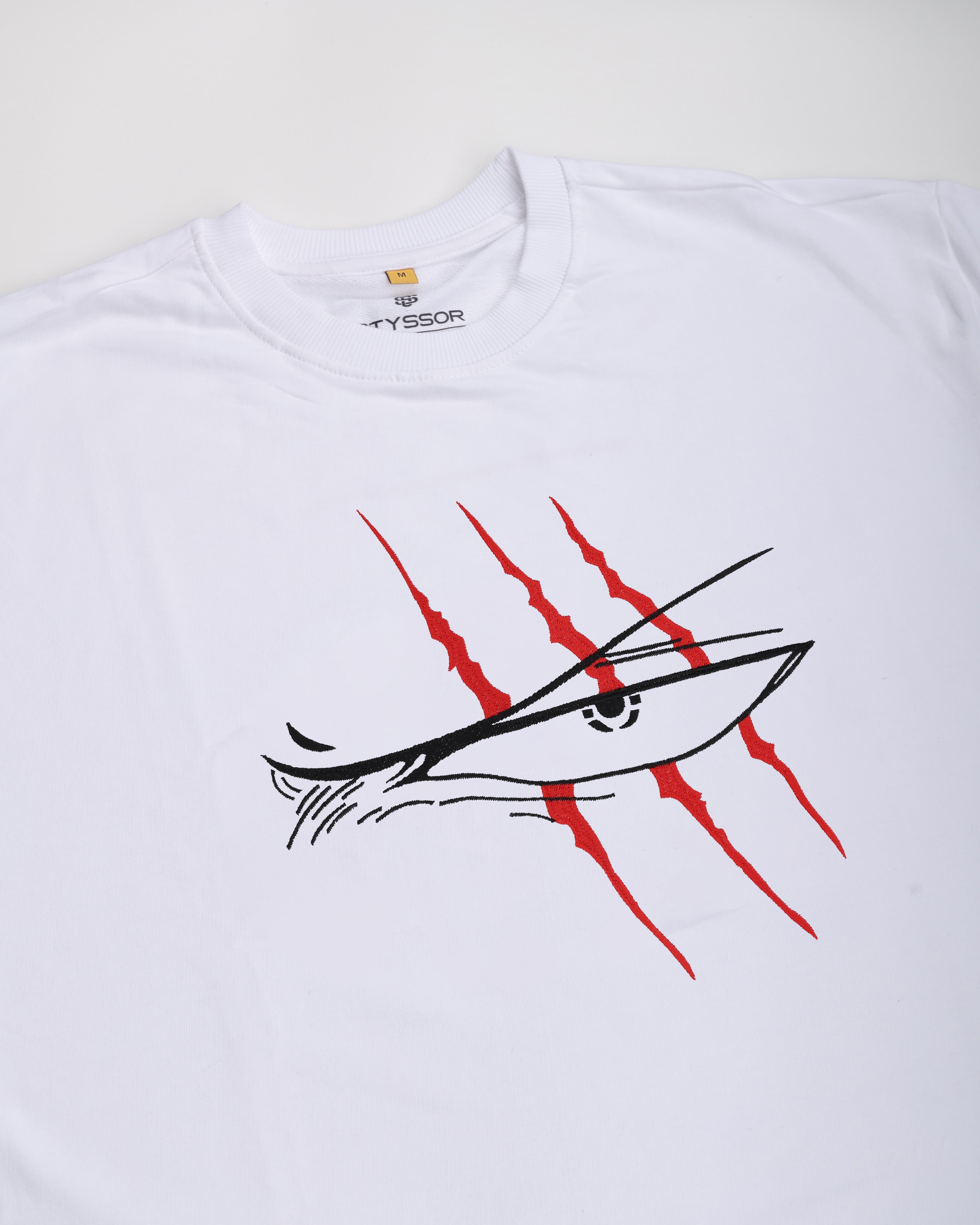 White t-shirt with red and black graphic design on a white background