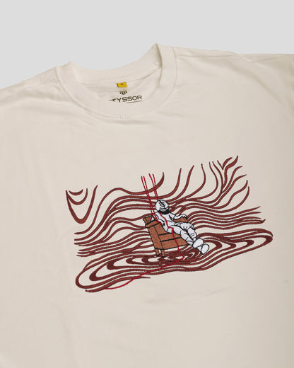 Beige t-shirt with a graphic design of a robot in a red wave on a white background