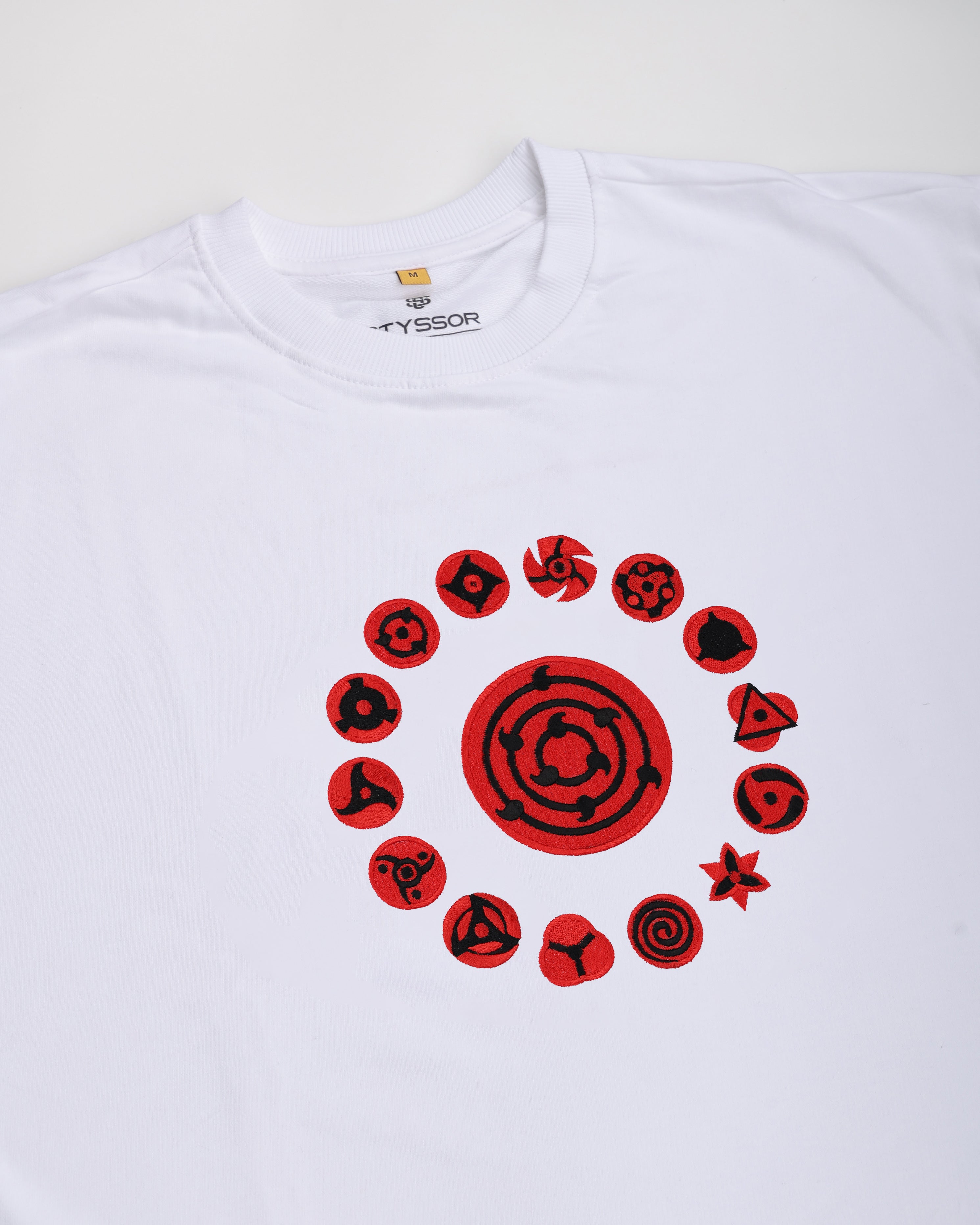 White t-shirt with red circular designs on a white background