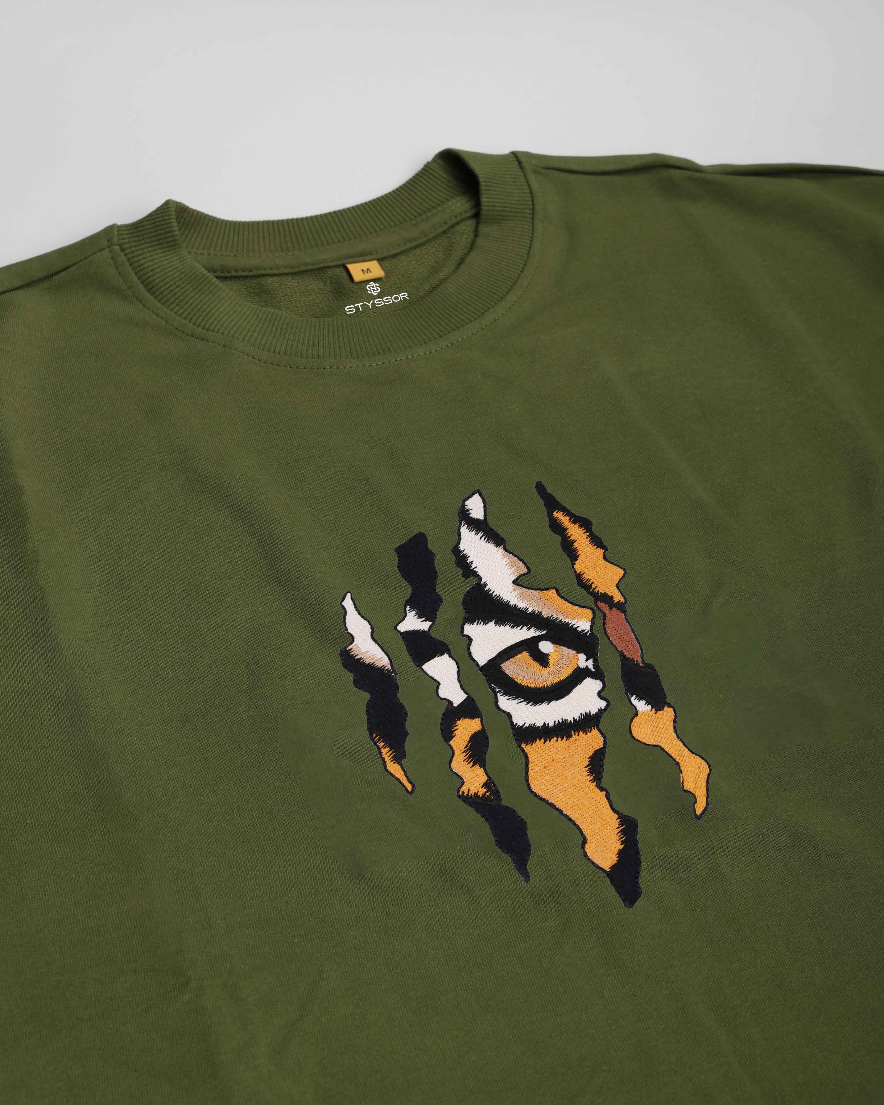 Green sweatshirt with a tiger eye design on a gray background