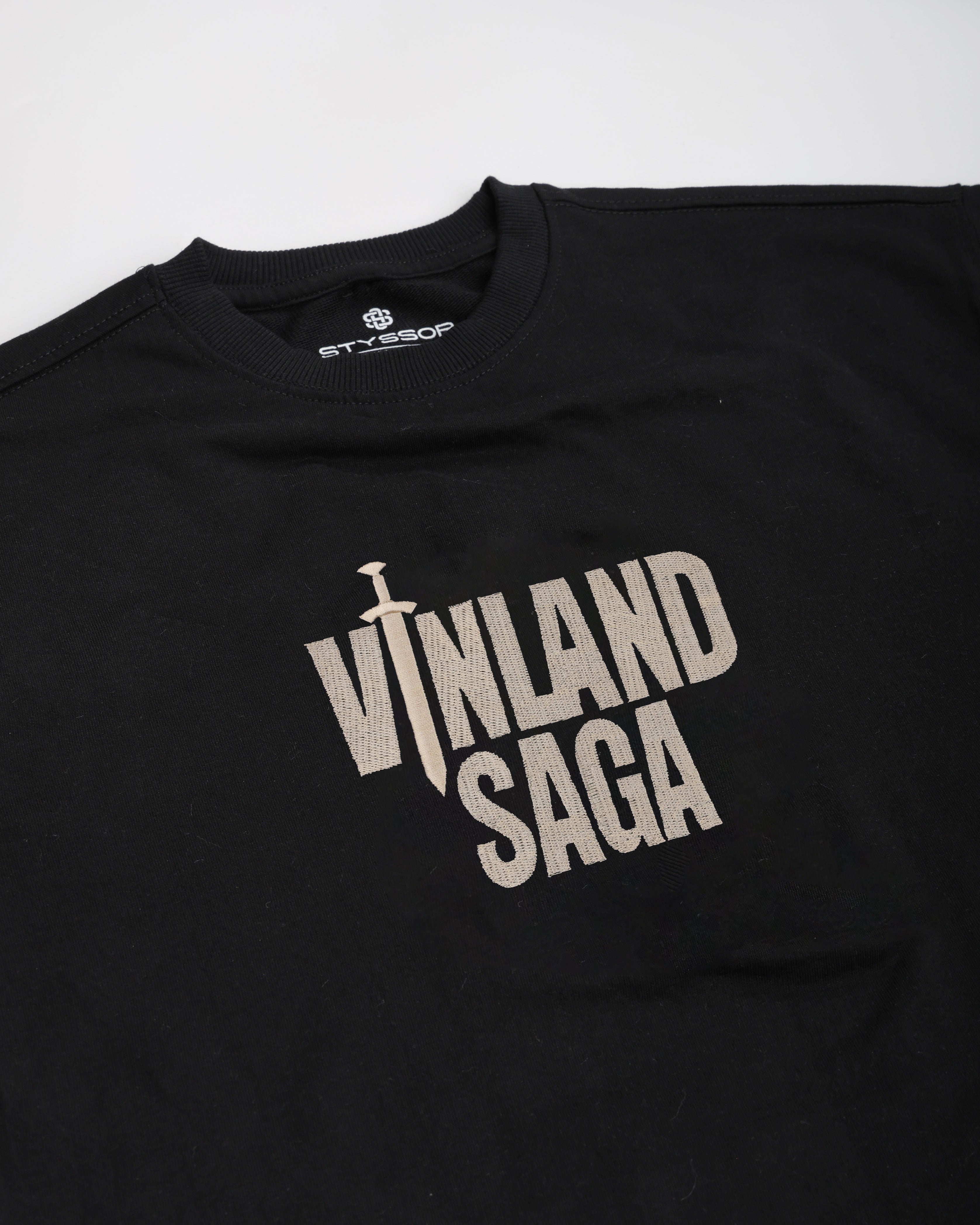 Black t-shirt with 'Vinland Saga' logo on a white background