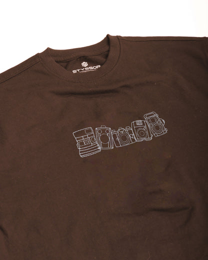Brown t-shirt with white graphic design on a white background