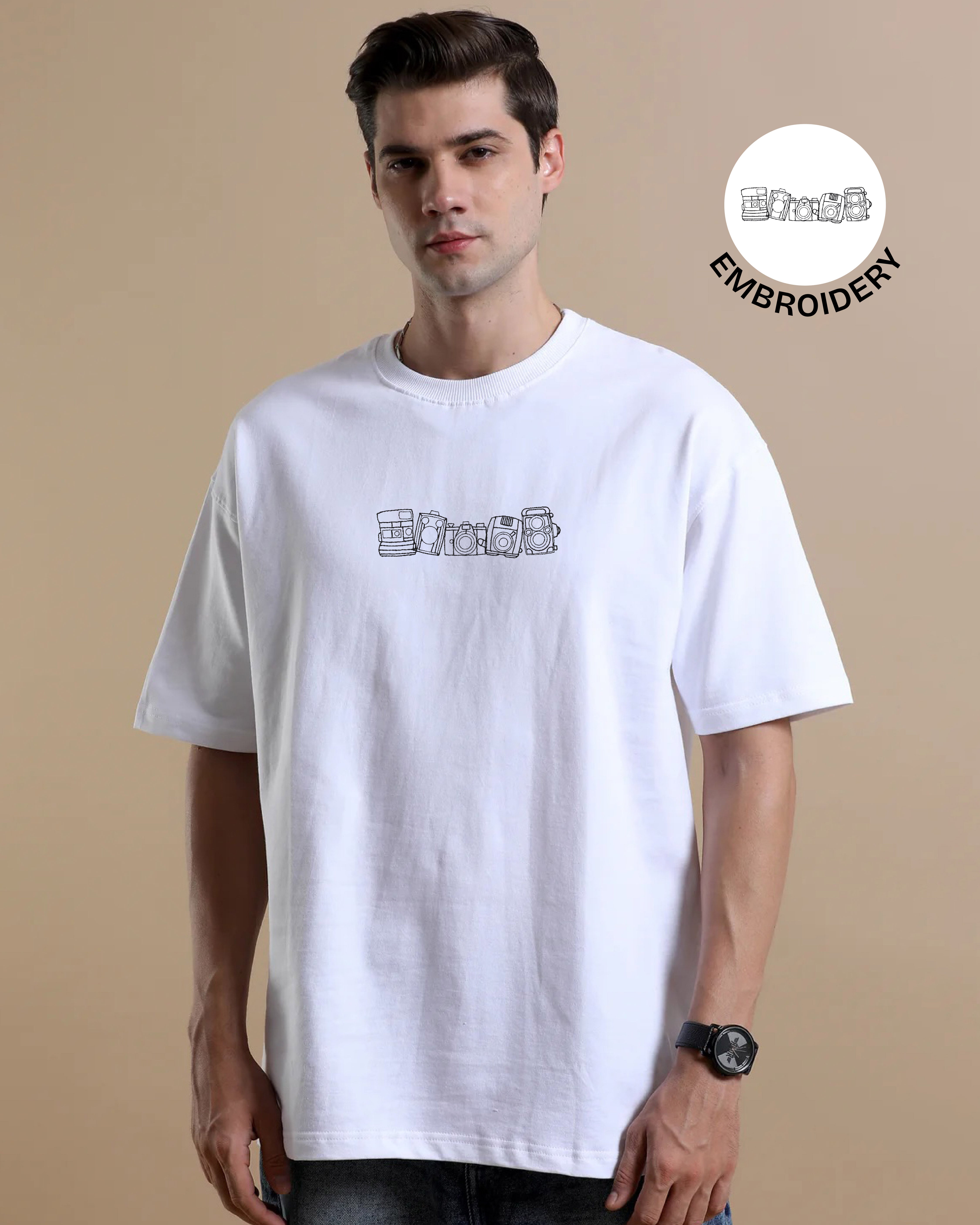 Man wearing a white t-shirt with embroidery design on a beige background