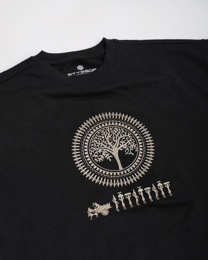 Black t-shirt with a white tree design and people figures on a white background
