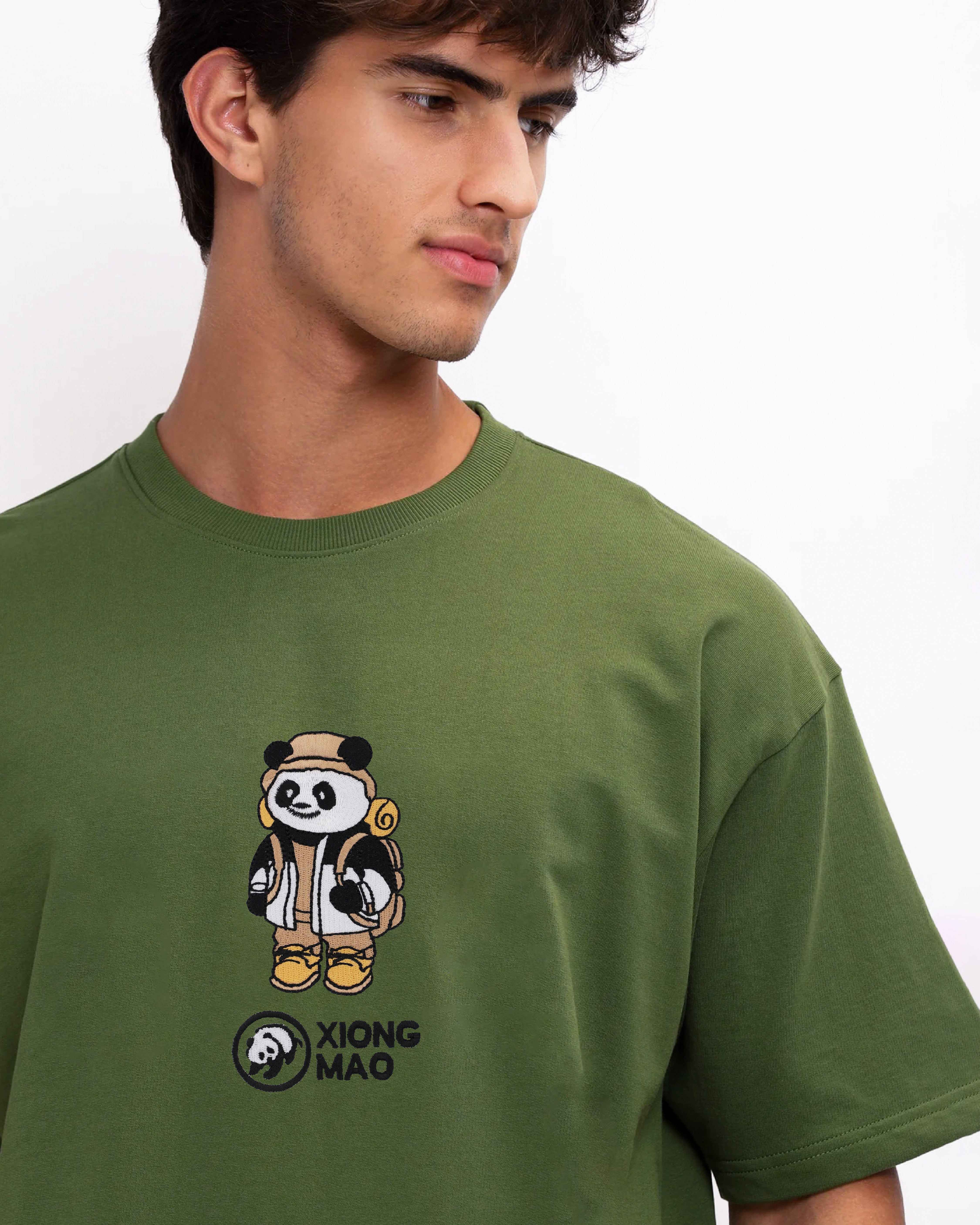 Man wearing a green t-shirt with a panda design and text on a white background